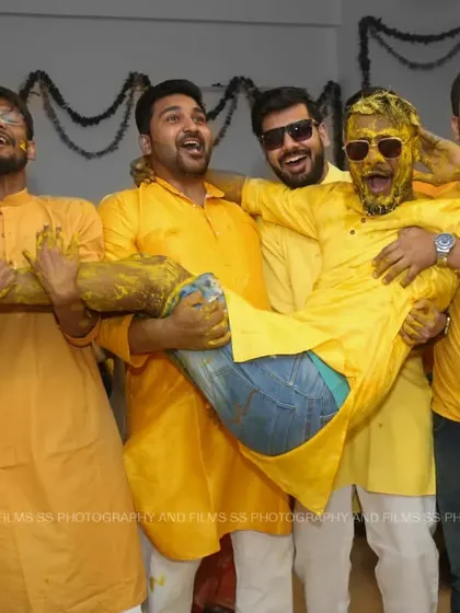 The Haldi ceremony is all about unrestrained fun, and we love capturing that energy. This shot of the groom and his friends perfectly encapsulates the joy and camaraderie of pre-wedding functions. We make sure to be in the middle of the action to capture these real moments.