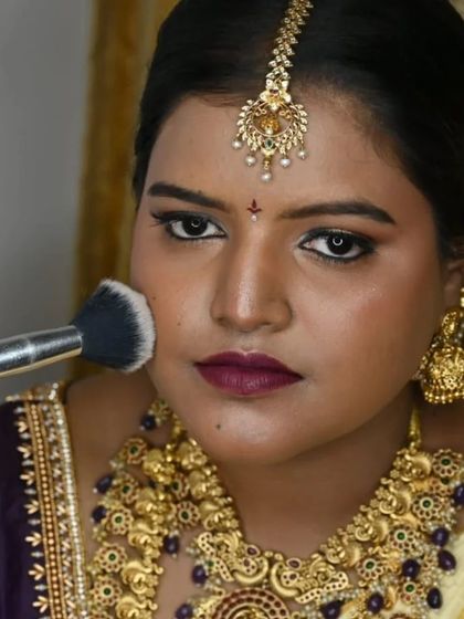 A behind-the-scenes look at the makeup process. Here, I am applying finishing powder to set the makeup, ensuring a long-lasting, flawless finish.