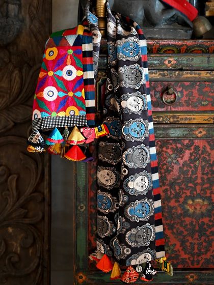 The runner is reversible, with one side featuring a bold Kalamkari goddess print. This adds versatility and another layer of storytelling to the piece.