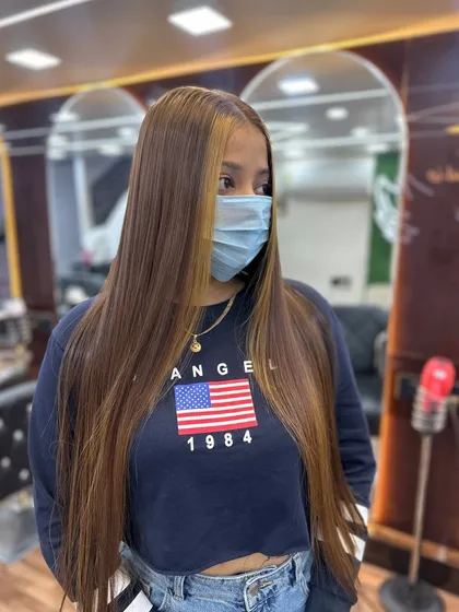A beautiful global hair color with subtle highlights around the face. The long, straight finish shows off the color perfectly.
