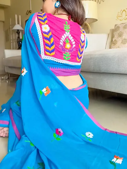 A close-up of the stunning hand-embroidered blouse back, paired with the blue mul saree. The craftsmanship is just incredible.