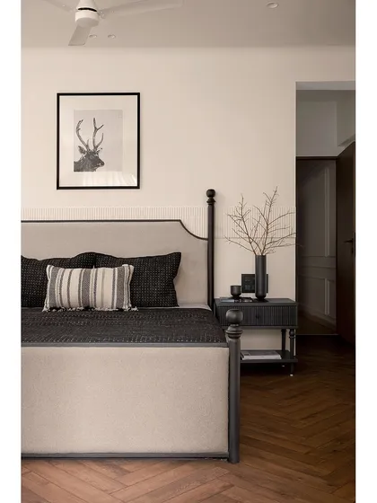 For this tranquil master bedroom, we designed a sophisticated half-poster bed as the centerpiece. Paired with herringbone flooring and a custom wardrobe with curved details, the room is a haven of understated elegance and modern comfort.