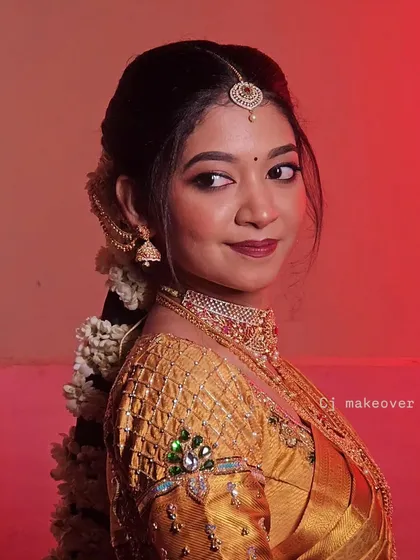 Wrapped in the elegance of a classic muhurtham look, this bride is ready for her temple wedding. The gold saree and traditional jewelry are the stars of the show.