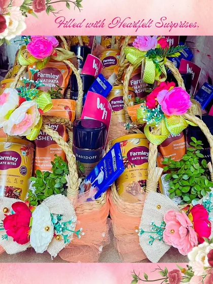 Heartfelt surprises prepared for a bulk order. These wicker baskets are filled with Farmley snacks, Davidoff coffee, and other gourmet items, each decorated with colorful flowers for a personal touch on a large scale.