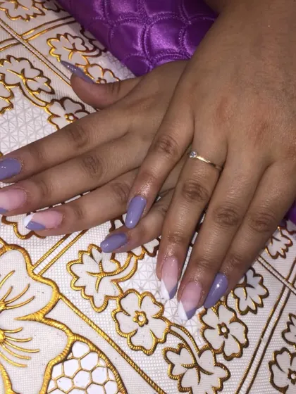 This V-shaped French manicure is a stylish and modern alternative to the classic curve. I used a lovely lilac color for the tips on these almond-shaped gel extensions.