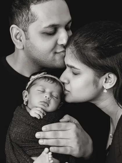 There is a timeless power in black and white photography. It strips away distractions and focuses on the pure emotion of the moment, like the tender, quiet love between new parents and their baby. These are the portraits that become family heirlooms.