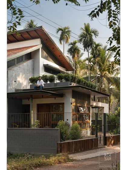 The home features a rooftop terrace with integrated planters, adding another layer of green to the structure.