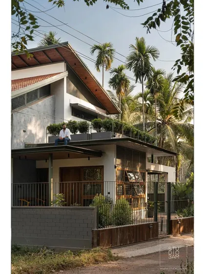 The home features a rooftop terrace with integrated planters, adding another layer of green to the structure.
