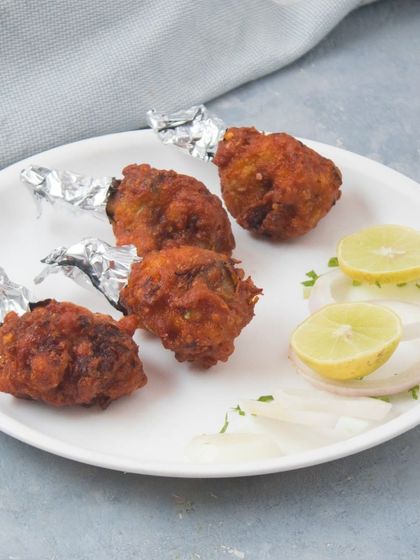 For those who prefer it simple, we offer Crispy Fried Chicken Lollipops without the sauce. They are served plain with a side of lemon and onions.