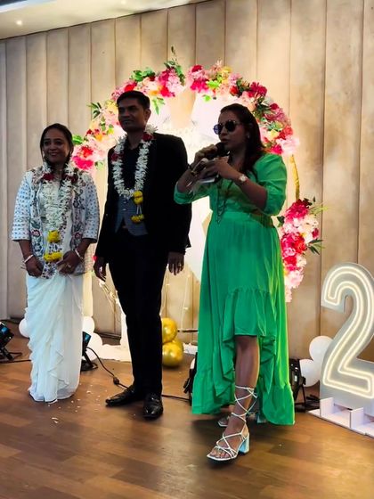 On stage with the happy couple, guiding them through a fun segment of their 25th anniversary party.