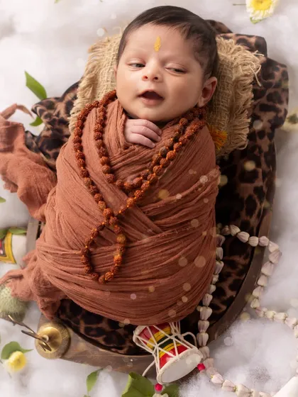 Another precious, authentic moment. This newborn, dressed as Lord Shiva, makes a tiny sound, adding to the story of his session.