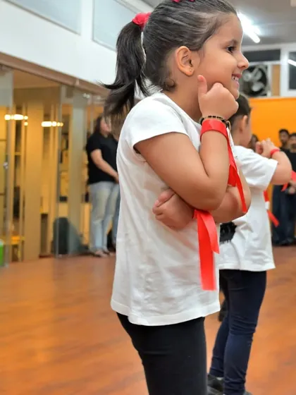 A candid shot of one of our young dancers, full of personality and ready for her cue.