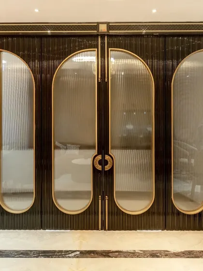The entrance to this luxury jewelry boutique was conceived as a statement of pure elegance. I designed these custom doors with fluted glass, brass accents, and intricate handles to create a dramatic and exclusive entryway that sets the tone for the opulent experience within.