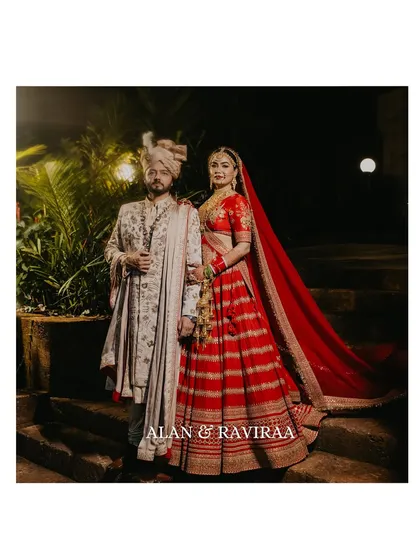 A classic portrait of the bride and groom on their wedding day. This image captures the regal elegance of their Sabyasachi outfits and the timeless love they share, a perfect memory from their celebrity wedding in Goa.