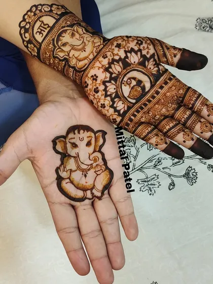 Here I've paired a cute baby Ganesha design for the dad to be with the mom's intricate baby shower mehndi, creating a beautiful and cohesive couple's look.