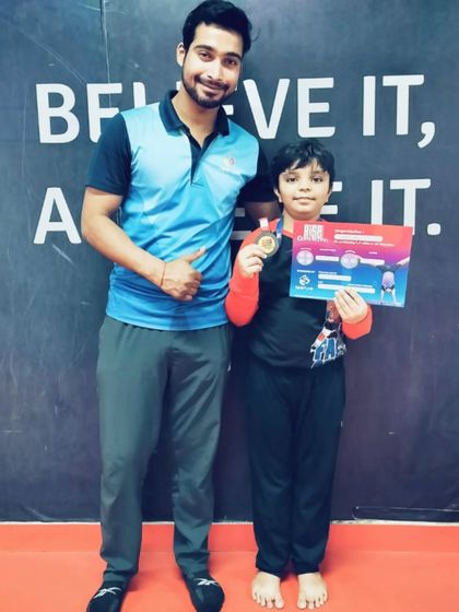 Thumbs up for this student who earned both a medal and a certificate.