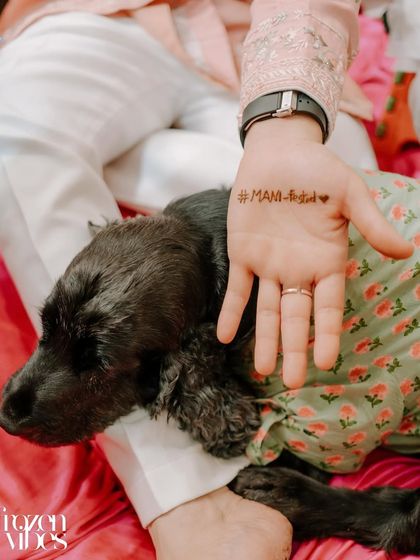 A close-up of the groom's Mehendi and his dog. This is a sweet, personal detail that tells a unique story about the couple.
