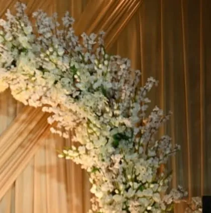 A close-up of the delicate white cherry blossom branches used to create a beautiful and ethereal floral arch.