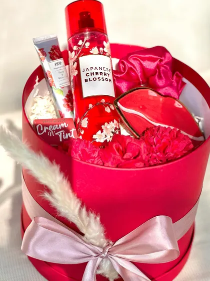 For the one whose favorite color is red! This round box hamper is filled with a Bath & Body Works "Japanese Cherry Blossom" fragrance mist, a lip-shaped trinket dish, and other red-themed goodies.