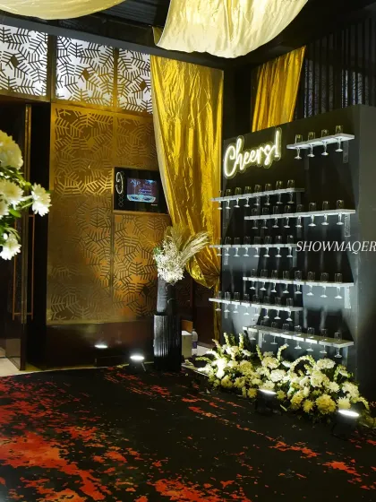 A creative and interactive "Cheers!" wall, designed to hold champagne glasses for guests. This feature is not only practical but also serves as a fantastic photo opportunity and decor element.