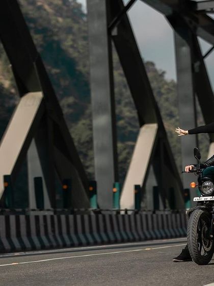 A joyful and carefree moment as the couple rides their motorcycle, with the bride's arms outstretched. This image perfectly captures the spirit of a fun-loving destination shoot.