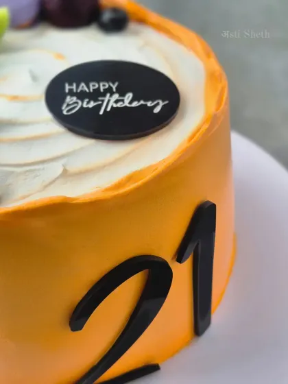 A detail shot of the 21st birthday cake, showing the smooth whipped cream finish and the "Happy Birthday" topper.