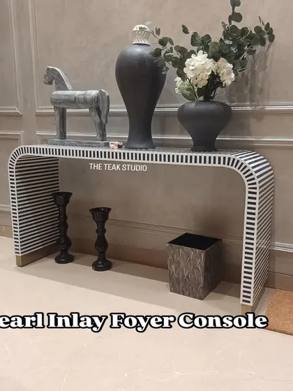 Make a stunning first impression with this pearl inlay foyer console. The striking black and white striped pattern is meticulously crafted using resin inlay, creating a waterfall design that is both modern and timeless. This piece adds bold character and artistic flair to any entryway or living room.