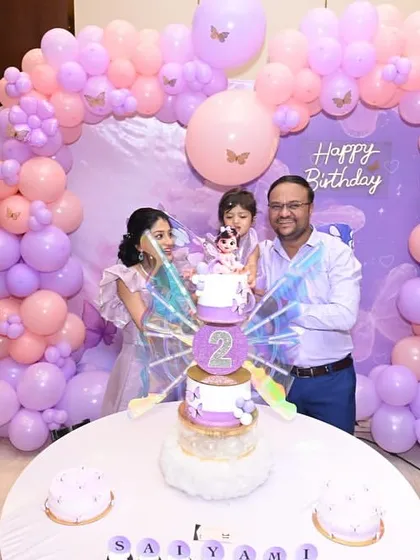 A family photo capturing the joy and excitement of a second birthday celebration.