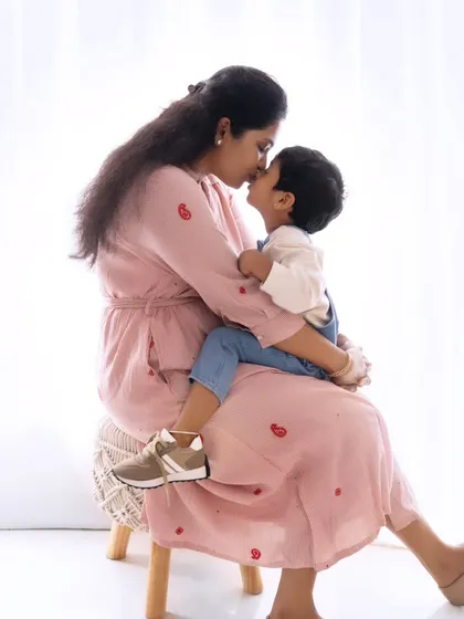 A sweet kiss between a mother and her son. These simple, affectionate moments are what make parent-child photoshoots so special.