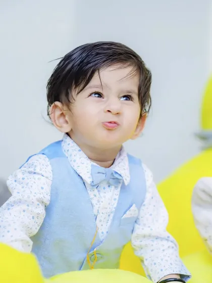 A playful pout from the birthday boy! Capturing a range of expressions, from giggles to funny faces, is key to telling the full story of your child's personality.