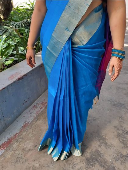 A close-up showcasing the beauty of a South Indian style drape. The pleats are perfectly aligned, and the hip is neatly defined.