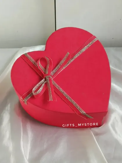 The simple and elegant packaging of the red heart-shaped chocolate box.