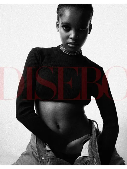 A powerful black and white portrait with graphic text overlay, styled like a magazine cover. The model's pose is strong, and the high-contrast look is modern and edgy.
