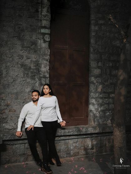 A stylish pre-wedding shot against a stone wall, capturing a moment of quiet connection. I work with couples to find poses that feel natural and reflect their personalities.