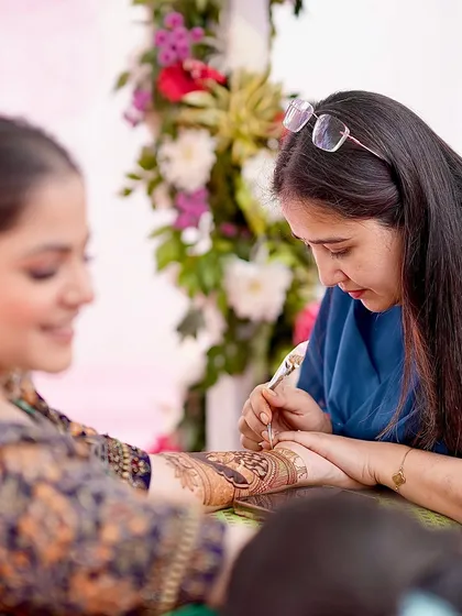 Focused on the art. Every stroke is placed with care and intention, ensuring the final design is as perfect as the bride's vision.