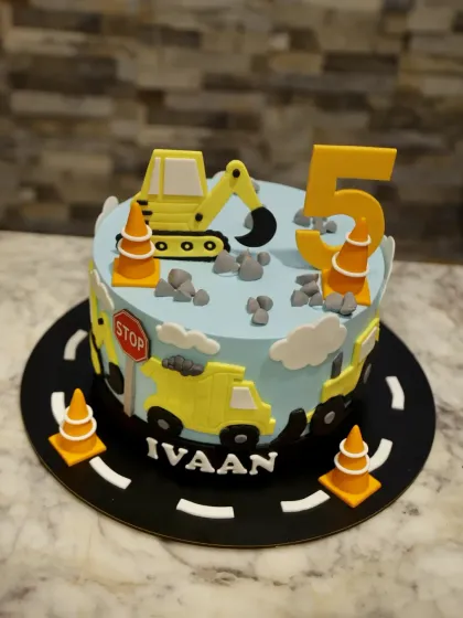A construction-themed cake for Ivaan's 5th birthday. Every detail, from the excavator to the traffic cones, is crafted to fit the theme.