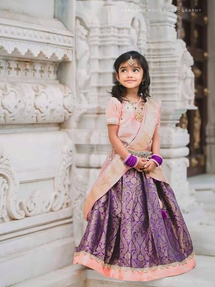 Another elegant portrait from the Vara Mahalakshmi shoot. The girl's serene expression and traditional attire are captured beautifully against the carved white stone backdrop.