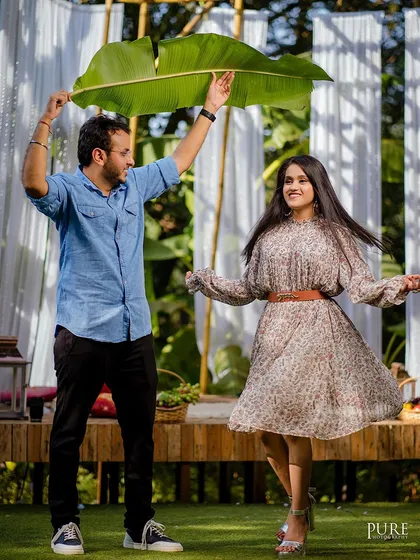 A fun and playful shot of Dheeraj and Navdeep, with him holding a large banana leaf as an umbrella. It shows how we encourage couples to be themselves and have fun during the shoot.