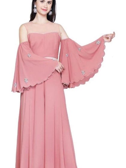 A lovely dusty rose gown with dramatic, floor-length bell sleeves featuring delicate crystal embellishments. The off-shoulder neckline adds a modern and romantic touch to this beautiful dress.