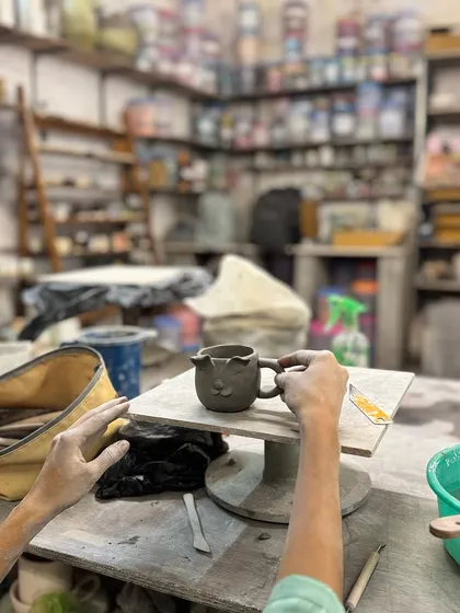 It all starts with an idea. Here, a student in our workshop is carefully hand-building a small cup, adding personal details. Our studio is a place to bring your own creativity to life, no matter how simple or complex.