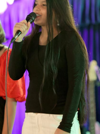 A young singer delivers a powerful vocal performance. We help our students find their voice and the confidence to share it with an audience.