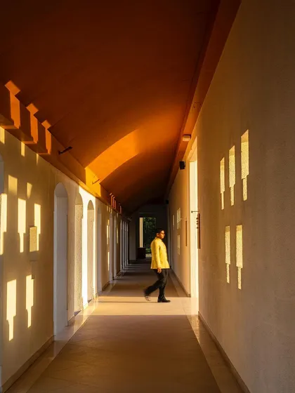 A corridor in the Bodhgaya hotel, where the architecture plays with light and shadow. The carefully placed openings create a rhythmic pattern, turning a simple passage into a meditative journey.