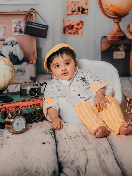 The full travel-themed setup for this 6-month-old's milestone session, complete with vintage props and a sense of adventure.