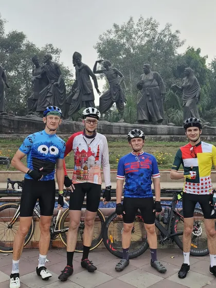 Four riders showcasing a variety of colorful and fun cycling jerseys.