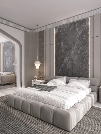 This 3D visualization presents a luxurious master suite with an adjoining living area. The design uses a cool gray palette, a statement marble headboard, and soft, ambient lighting to create a sophisticated and restful environment.
