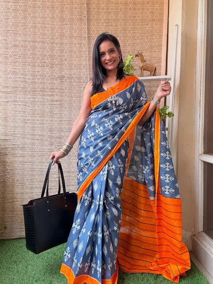 This pre-stitched cotton saree in a grey and orange ikat print is perfect for the office. It's stylish, comfortable, and saves you draping time.