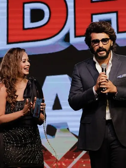 Sharing a moment on stage with Arjun Kapoor. I am experienced in managing the stage with celebrity guests, ensuring a smooth and engaging segment for everyone.