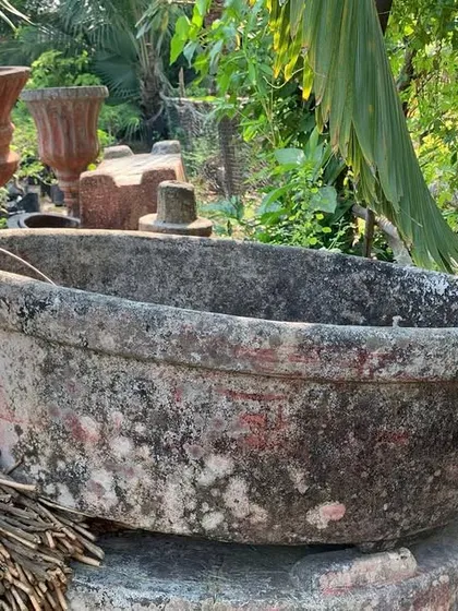 I source unique pieces like this large, weathered stone basin to create custom water features or ponds. This kind of rustic element can add a lot of character and a sense of history to a garden space.