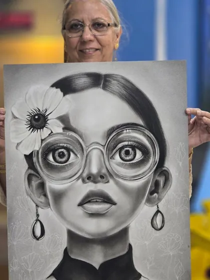 Here is one of our dedicated students proudly presenting her completed charcoal portrait. We believe in celebrating every artist's journey and the incredible progress they make at our institute.