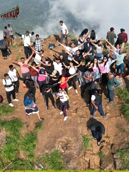An aerial shot of our group on a cliff edge during the Netravathi trek, celebrating their climb together.